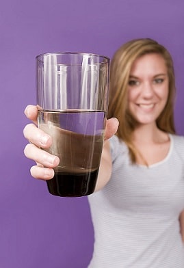 Young woman holding a glass of water