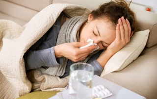 Sick Woman. Flu. Woman Caught Cold. Sneezing into Tissue