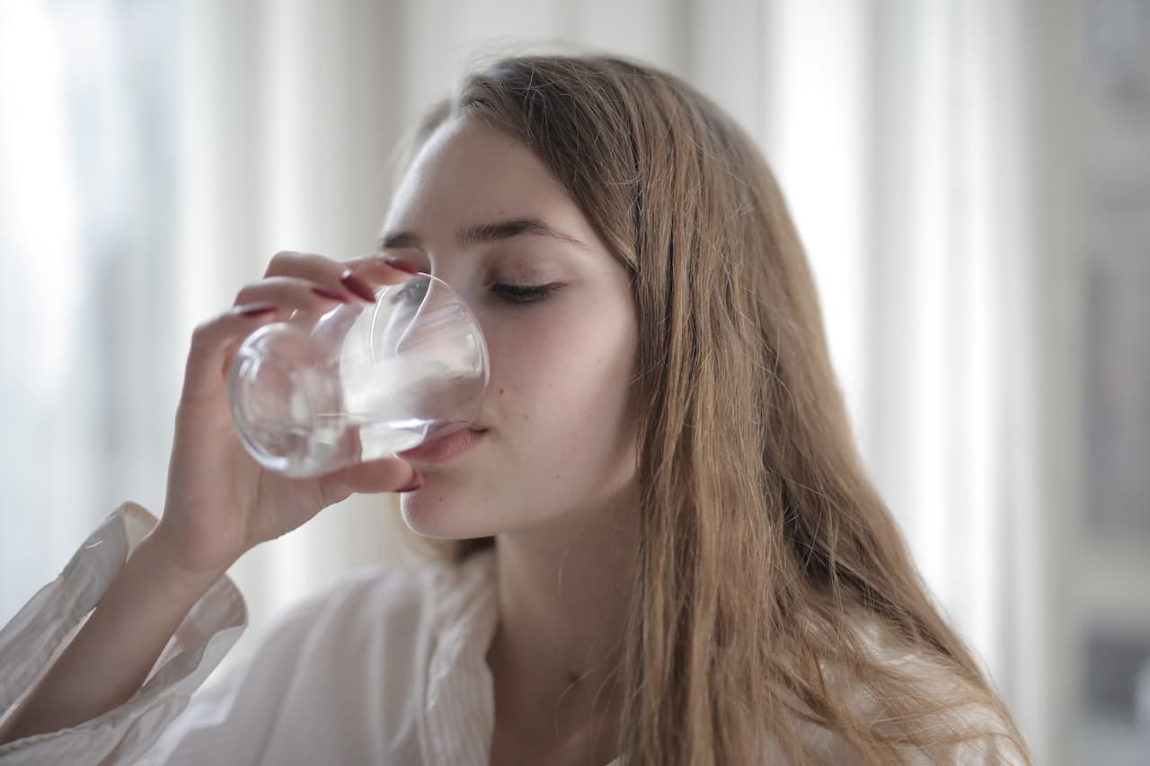 Woman enjoys a refreshing glass of water